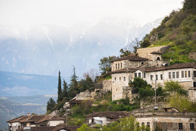 High angle view of townscape by mountains against sky