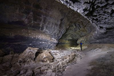 Man standing on rock in cave