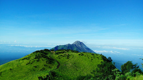 Scenic view of mountains against blue sky