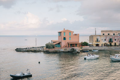 Boats in sea against sky