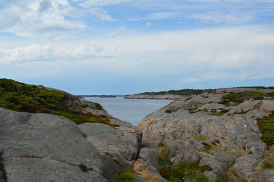 Rocks on beach against sky