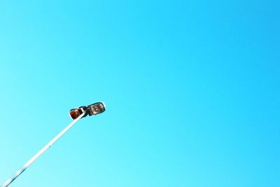 Low angle view of street light against clear blue sky