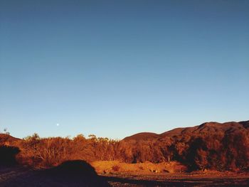 Scenic view of mountains against clear blue sky