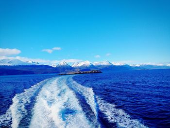 Beagle channel with the trail of a boat in the background the snow-capped andes