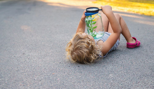 High angle view of woman sitting on road