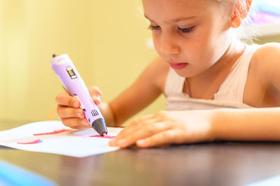 Midsection of girl holding table