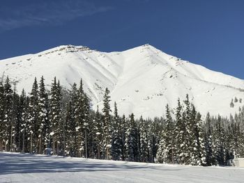 Scenic view of snow covered mountains against sky