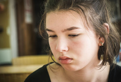 Close-up of sad girl looking down