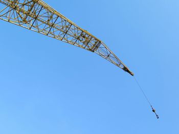 Low angle view of windmill against clear blue sky