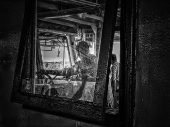 Man seen through glass window