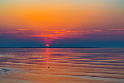 Scenic view of sea against romantic sky at sunset