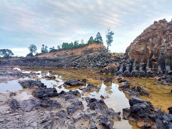 Rocks on shore against sky