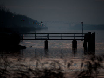 Pier on sea at sunset