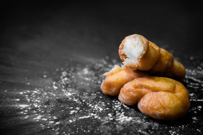 Close-up of bread on table against black background