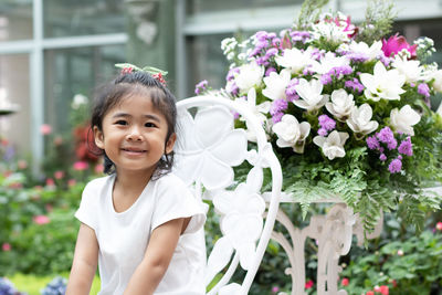 Portrait of smiling girl with flowers