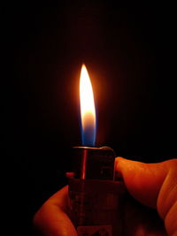 Close-up of hand holding candle