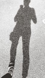 Shadow of man on road