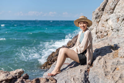 Portrait of man on rock at beach