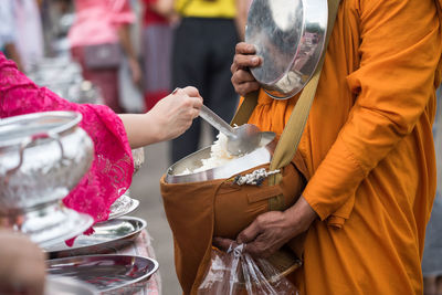 Midsection of people working in temple