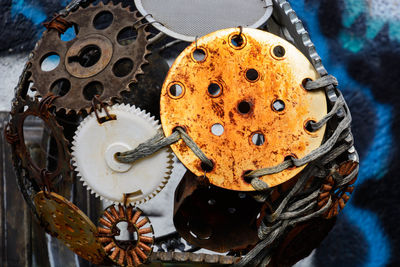 Close-up of artwork made from rusty gears