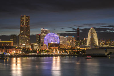 Panorama sunset view of the cosmo clock 21 big wheel, landmark tower and pacifico yokohama building.