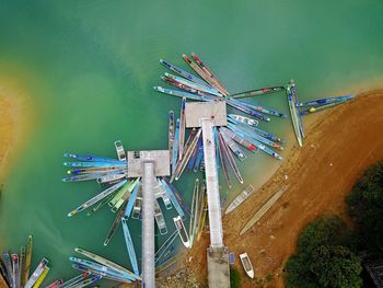 High angle view of ferris wheel by river against sky