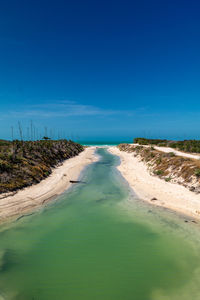 Scenic view of land against clear blue sky