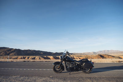 Motorcycle on road against sky