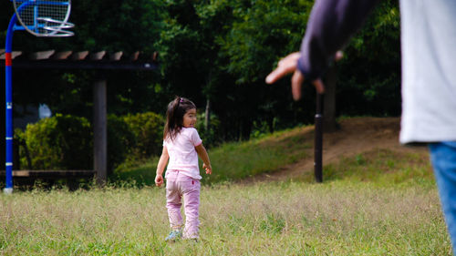 Girl standing on grassy field