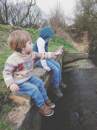 Side view of brothers sitting