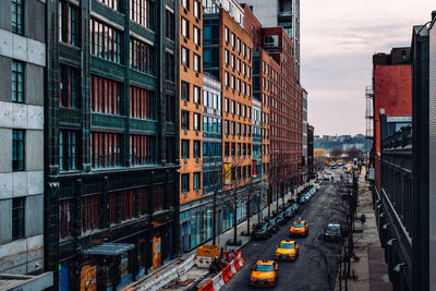 Cars on street amidst buildings in city