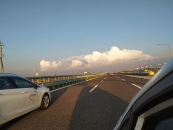 Cars on road against sky