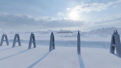 Panoramic view of people on snowcapped mountains against sky