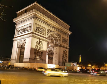 Statue in city at night