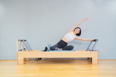 Low section of woman exercising in gym