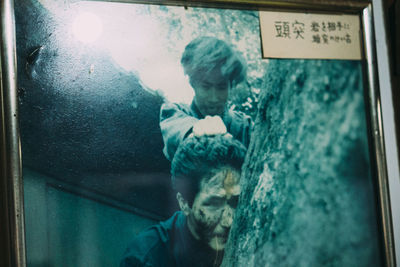 Portrait of child looking through window