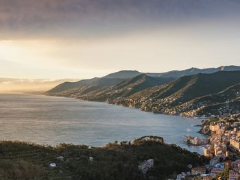 Scenic view of sea by city against sky