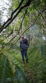 Portrait of man standing in forest