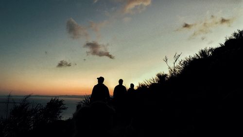 Silhouette people against sky during sunset