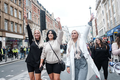 Young women standing on city street