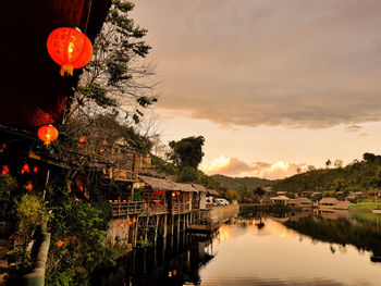 Scenic view of river against sky at sunset
