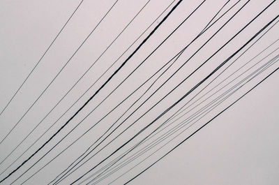 Low angle view of cables against clear sky