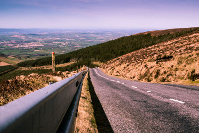 Scenic view of road on mountain against sky