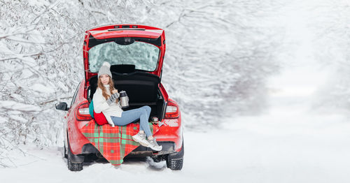 Woman sitting in snow