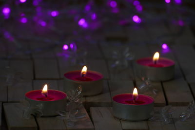 Close-up of lit candles burning candle