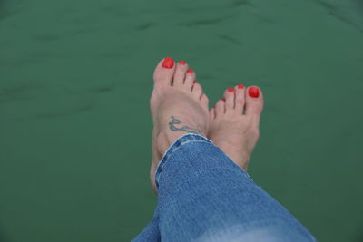 Low section of woman legs in water