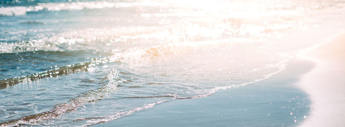 Panoramic view of sea waves on sunny day