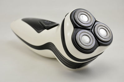 Close-up of camera on table against white background