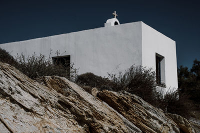 Low angle view of a chapel built on rocks.