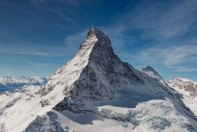 Scenic view of snow covered mountains against sky